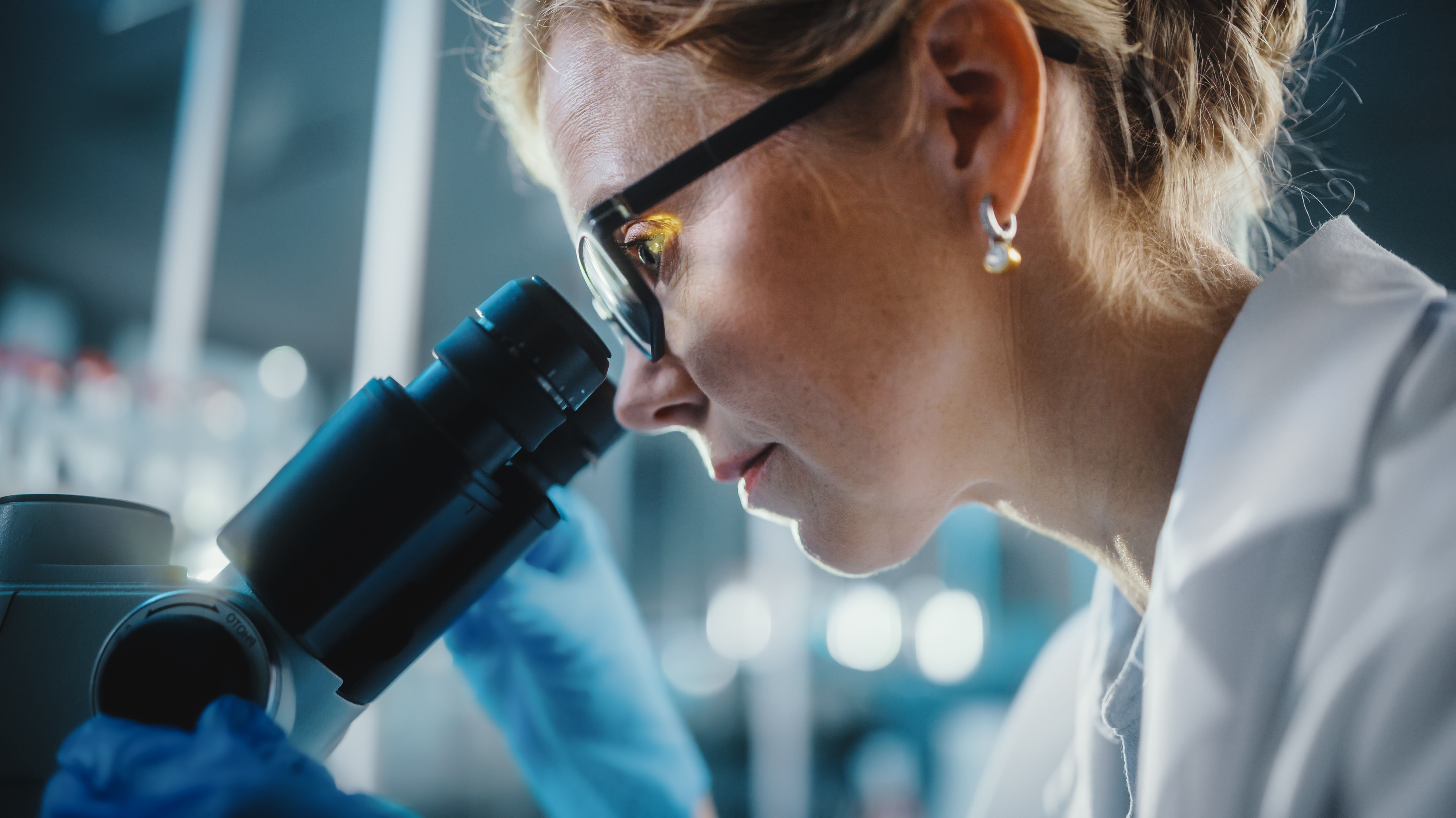 Female researcher at microscope