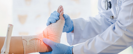 Doctor examining injured foot and ankle