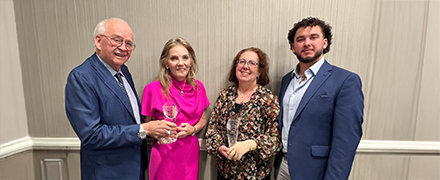 photo of two men and two women accepting an award